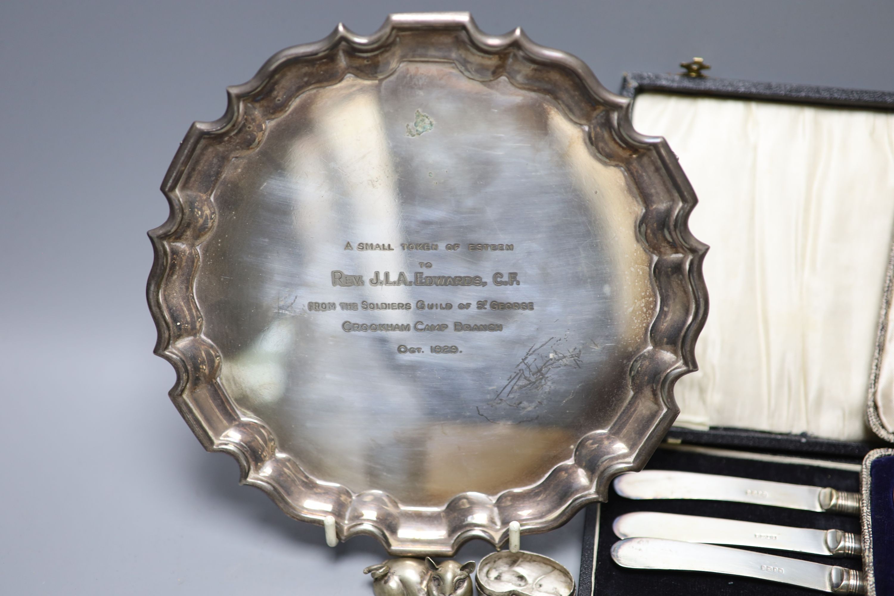 Mixed small silver and plated wares including sterling cup, repousse silver boxes, cased silver teaspoons, silver card case, 925 whistle, plated Art Nouveau aide memoire, plated salver etc.